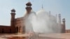 Volunteers disinfects the historical Badshahi Mosque ahead of the Muslim fasting month of Ramadan, in Lahore, Pakistan, April 22, 2020. 