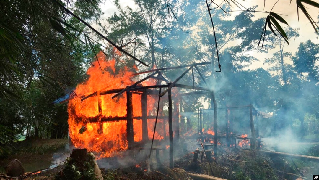 FILE - In this Sept. 7, 2017, photo, houses are on fire in Gawdu Zara village, northern Rakhine state, Myanmar. 