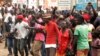 FILE - Supporters of Ugandan musician-turned-politician Robert Kyagulanyi Ssentamu, also known as Bobi Wine, chant slogans outside his home in Kampala, after he returned from the U.S., Sept. 20, 2018.