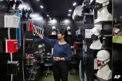 An Indian woman looks for air pollution mask inside a shop in New Delhi, India, Nov. 4, 2016. A new report from UNICEF says about a third of the 2 billion children in the world who are breathing toxic air live in northern India and neighboring countries.