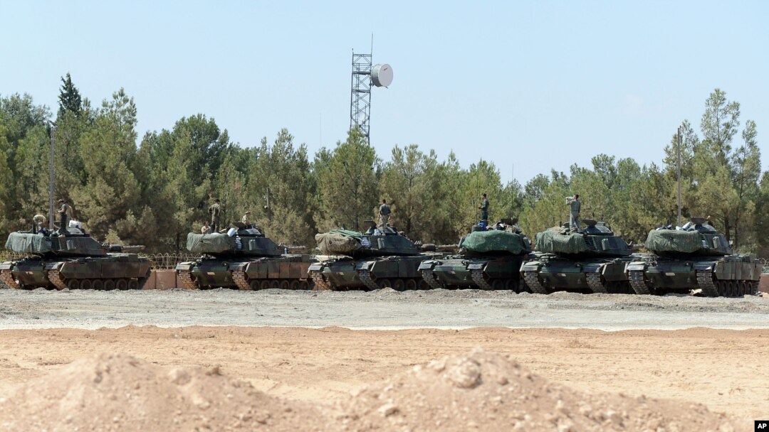 FILE - Turkish tanks stationed near the Syrian border, Sept. 3, 2016. Turkey's state-run news agency says Turkish tanks have entered Syria's Cobanbey district northeast of Aleppo in a "new phase" of the Euphrates Shield operation.