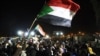 Sudanese protesters celebrate after an agreement was reached with the military council to form a three-year transition period for transferring power to a full civilian administration, in Khartoum, May 15, 2019.
