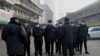 Security guards stand in front of the closed Huanan wholesale seafood market, where health authorities say a man who died from a respiratory illness, had purchased goods from, in the city of Wuhan, Hubei province, China, Jan. 12, 2020.