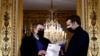 FILE - French President Emmanuel Macron meets historian Benjamin Stora for the delivery of a report on Algeria's colonization and war, at the Elysee Palace in Paris, France, Jan. 20, 2021. 