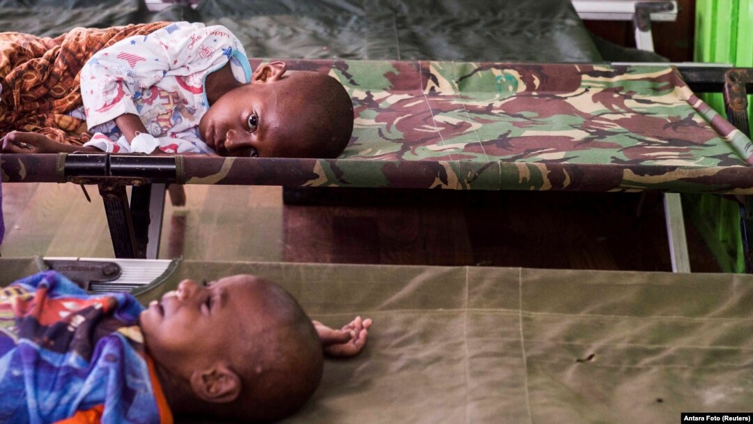 FILE - Two sick children wait for treatment after being admited to a hospital in Agats, Asmat District, after the government dispatched military and medical personnel to the remote region of Papua to combat malnutrition and measles, Indonesia, Jan. 22, 2018. (Antara Foto/M Agung Rajasa/ via REUTERS)