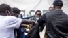 FILE - A man is arrested during a protest against police brutality and harassment, especially against the poor, in Nairobi on July 7, 2021.
