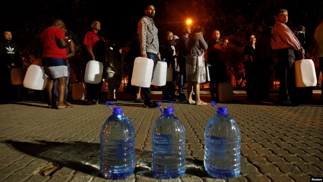 People queue to collect water from a spring in the Newlands suburb as fears over the city's water crisis grow in Cape Town, South Africa, Jan. 25, 2018.