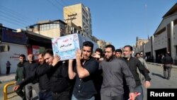 People carry a coffin during a funeral of the victims of assault that killed 25 people, in the streets of the southwestern Iranian city of Ahvaz, Iran, Sept. 24, 2018. 