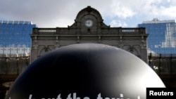 FILE - The words "Knock out the toxic tonnes" are seen on a giant ball during a protest by environmental activists in front of the European Parliament in Brussels , Belgium.