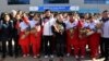 Sarah Murray, center, head coach of the combined women's ice hockey team is seen as North Korean women's ice hockey players arrive at the South Korea's national training center, Jan. 25, 2018, in Jincheon, South Korea.