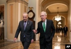 Senate Majority Leader Mitch McConnell, R-Ky., and Senate Minority Leader Chuck Schumer, D-N.Y., left, walk to the chamber after collaborating on an agreement on a two-year, nearly $400 billion budget, Feb. 7, 2018.