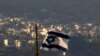 FILE - An Israeli flag flies near the village of Majdal Shams in the Golan Heights, Oct. 11, 2018.
