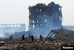 Relatives look for a missing worker at the pesticide plant owned by Tianjiayi Chemical following an explosion, in Xiangshui county, Yancheng, Jiangsu province, China, March 23, 2019.