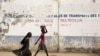 FILE - Girls walk on a road in Maroua, Cameroon, March 17, 2016. 