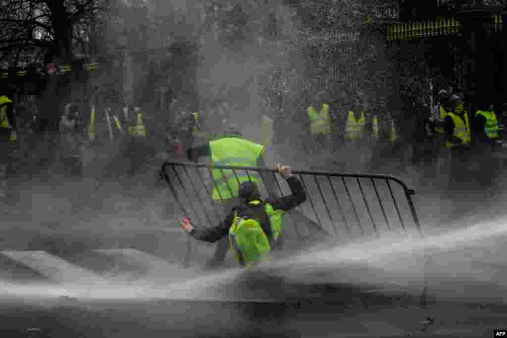 Anti-riot police use a water cannon during clashes with 'yellow vest' (Gilet Jaune) protesters during a demonstration, near major EU buildings in Brussels, Belgium.
