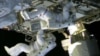 In this still image taken from NASA TV, International Space Station astronauts Chris Cassidy (top) and Tom Marshburn work on repairs to the ISS on May 11, 2013. 