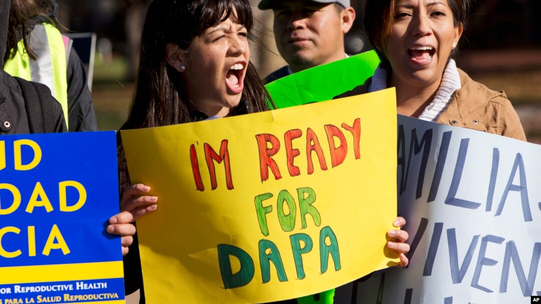 Danna Chavez Calvi, 23, (left) and a young woman who requested not to be named, participate in a rally for immigration reform after marching from Arlington, Va., to the White House in Washington, Nov. 20, 2015.
