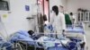 FILE - A doctor cares a patient who is infected with the COVID-19 in the Intensive Care Unit at Martini hospital in Mogadishu, Somalia, July 29, 2020.