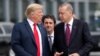 FILE - U.S. President Donald Trump and Turkish President Recep Tayyip Erdogan converse at the start of a NATO summit in Brussels, Belgium, July 11, 2018.