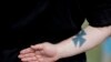 FILE - A neo-Nazi attends a rally in Newnan, Georgia, USA, April 21, 2018. 