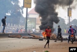 FILE - People demonstrate to denounce the results of the local elections, on Feb. 6, 2018 in Conakry.
