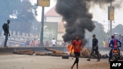 FILE - People demonstrate to denounce the results of the local elections, on Feb. 6, 2018 in Conakry.