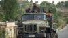 FILE - Ethiopian government soldiers ride in the back of a truck on a road leading to Abi Adi, in the Tigray region of northern Ethiopia, May 11, 2021.
