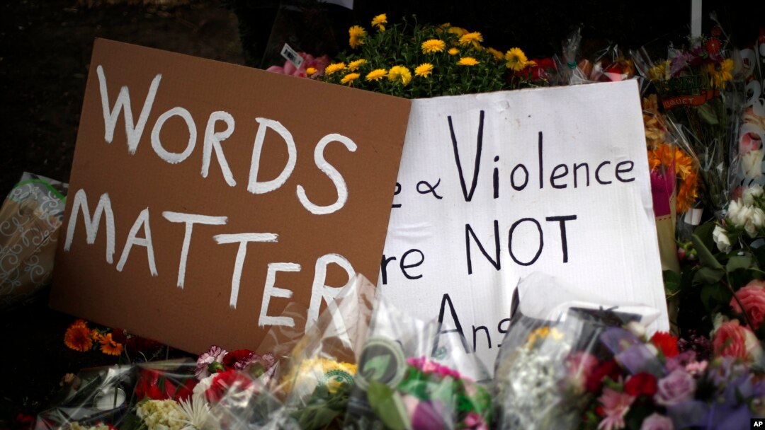 Flowers surround signs on Oct. 31, 2018, part of a makeshift memorial outside the Tree of Life synagogue to the 11 people killed during worship services Oct. 27, 2018, in Pittsburgh.