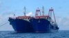 In this photo provided by the National Task Force-West Philippine Sea, Chinese vessels are moored at Whitsun Reef, South China Sea on March 27, 2021. 