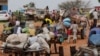 FILE - Chadian cart owners transport belongings of Sudanese people who fled the conflict in Sudan's Darfur region, while crossing the border between Sudan and Chad in Adre, Chad, on Aug. 4, 2023.