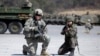 FILE - A U.S. Army soldier and a South Korean Army soldier take their position during joint military exercises between South Korea and the United States in Pocheon, north of Seoul, South Korea, March 25, 2015.