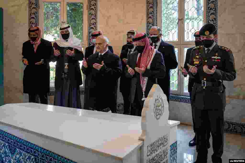 Jordan's King Abdullah II and members of the royal family including former crown prince and half-brother Prince Hamza pray at tombs of royalty in the Raghdan Palace in Amman, Jordan. (Jordanian Royal Palace/Handout)