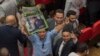 A man reacts after the National Electoral Authority declares incumbent president Abdel Fattah el-Sissi the winner of the presidential election, Cairo, Egypt, April 2, 2018. (H. Elrasam/VOA) 