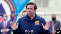 Florida Gov. Ron DeSantis speaks during a news conference at a COVID-19 testing site at Hard Rock Stadium, during the new coronavirus pandemic, May 6, 2020, in Miami Gardens, Fla.