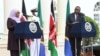 Kenya's President Uhuru Kenyatta, right, listens as Tanzanian President Samia Suluhu Hassan speaks during a joint press conference at the State House in Nairobi, May 4, 2021. 