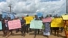 Schoolchildren, their parents and teachers hold a protest after gunmen opened fire at a school, killing at least six children as authorities claim, in Kumba, Cameroon, Oct. 25, 2020. 