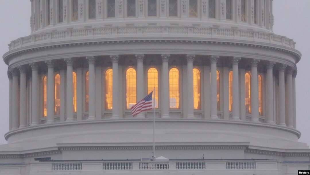 FILE - A United States flag flies in front of the U.S. Capitol dome in Washington, Nov. 6, 2018.
