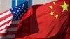 U.S. flag and China's flag flutter in winds at a hotel in Beijing, Sept. 5, 2012.