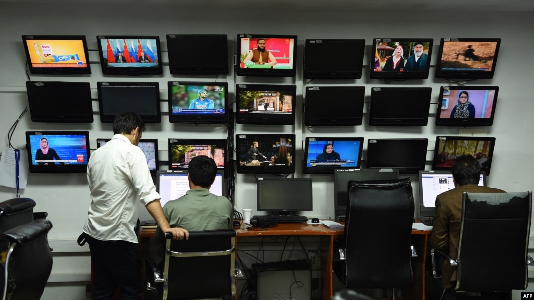 FILE - Afghan reporters work in the newsroom at Tolo TV in Kabul, Sept. 11, 2018.