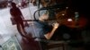 A man surfs the Internet on his tablet device at a coffee shop in downtown Shanghai September 25, 2013.
