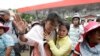 Cambodians cry outside a shopping mall where prominent political analyst Kem Ley was shot dead in Phnom Penh, Cambodia, Sunday, July 10, 2016.