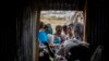 FILE - Tigrayans stand in line to receive food donated by local residents at a reception center for the internally displaced in Mekele, in the Tigray region of northern Ethiopia, on May 9, 2021. 