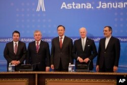 From left, Turkish Foreign Ministry Deputy Undersecretary Sedat Onal, Russia's special envoy on Syria Alexander Lavrentiev, Kazakh Foreign Minister Kairat Abdrakhmanov, UN Syria envoy Staffan de Mistura and Iran's Deputy Foreign Minister Hossein Jaber Ansari stand for a photo after the final statement following the talks on Syrian peace in Astana, Kazakhstan, Jan. 24, 2017.