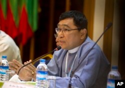 FILE - Win Myat Aye, Myanmar's social welfare minister, who is leading the repatriation process, talks to journalists during a press briefing, April. 19, 2018, in Yangon, Myanmar.
