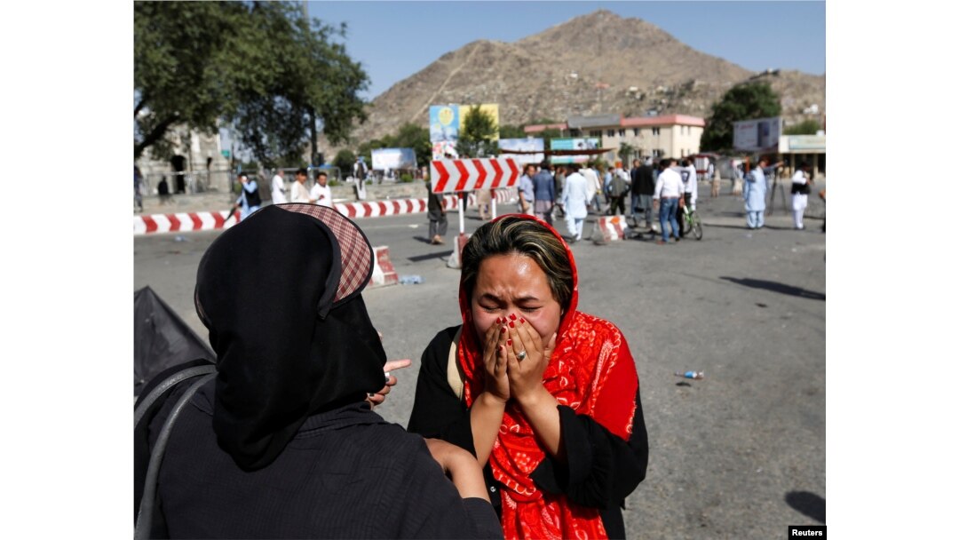An Afghan woman weeps at the site of a suicide attack in Kabul, Afghanistan July 23, 2016.