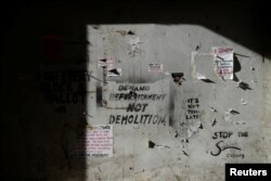 FILE - Graffiti is seen in southeast London, Britain, Oct. 6, 2016. Feeling trapped and vulnerable in their own destitude neighborhoods, many youngsters say they are joining gangs for their own protection.