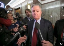 Sen. Lindsey Graham, R-S.C., speaks to reporters as he leaves the office of Sen. Susan Collins, R-Maine, who is moderating bipartisan negotiations on immigration, at the Capitol in Washington, Jan. 25, 2018.