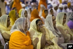 FILE - Mourners attend the funeral and memorial service for the six victims of the Sikh temple of Wisconsin mass shooting in Oak Creek, Wisconsin, Aug. 10, 2012.