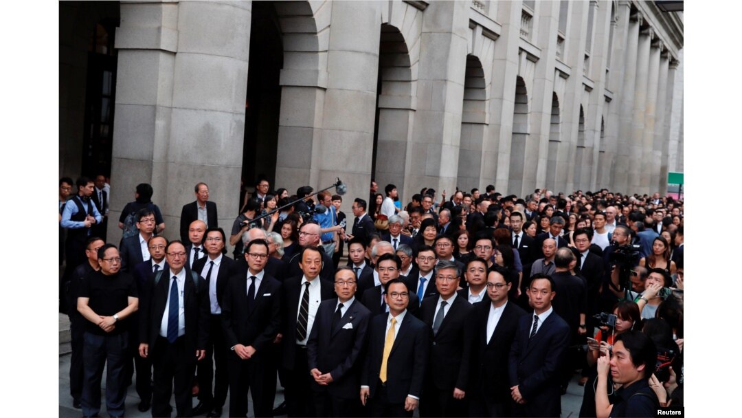 Thousands of legal professionals wearing black, stage a silent protest to the Central Government Offices, demanding authorities scrap a proposed extradition bill with China, in Hong Kong, June 6, 2019.