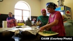 FILE - Members of the Sikh Temple in Oak Creek, Wisconsin, prepare a communal meal for the community.